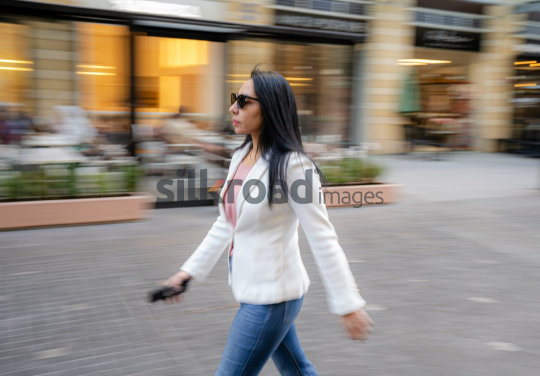 Dynamic Panning Shot of a Woman Walking at Amman’s Abdali Boulevard