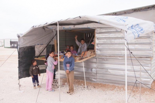 small shop and kids trying to buy and sell from Zaatari refugee camp for Syrian refugees