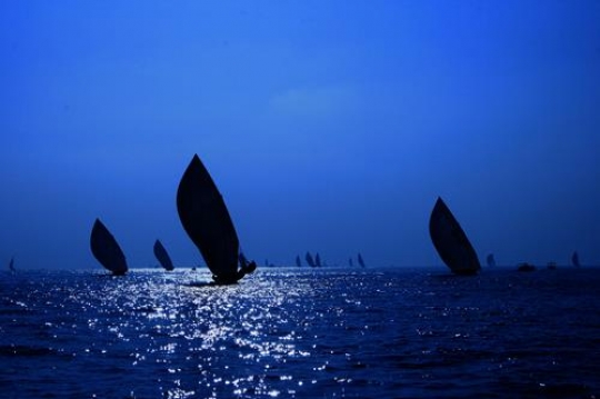 athletes sailing boats in the 
