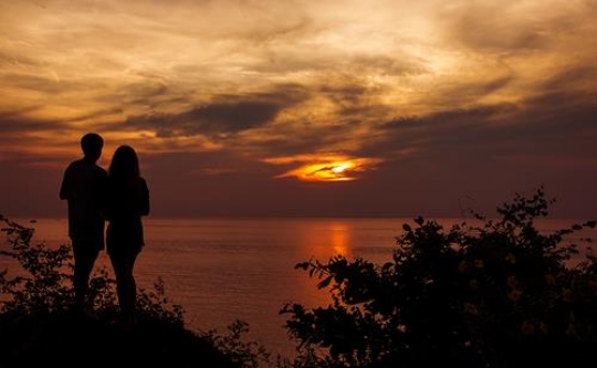 romantic silhouette of a loving couple on honeymoon looking