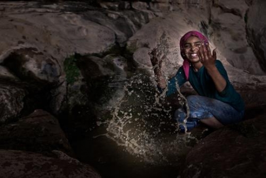 bedouin girl playing in the water