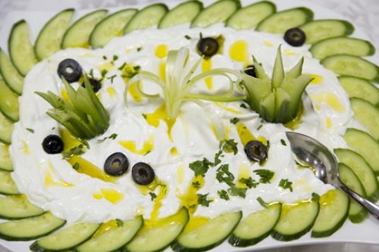 milk curd yogurt dish with cucumber slices and olive oil