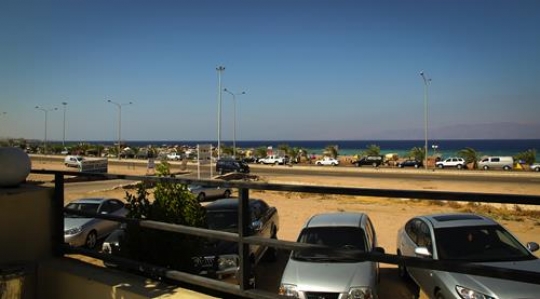car parked outside a beach entrance