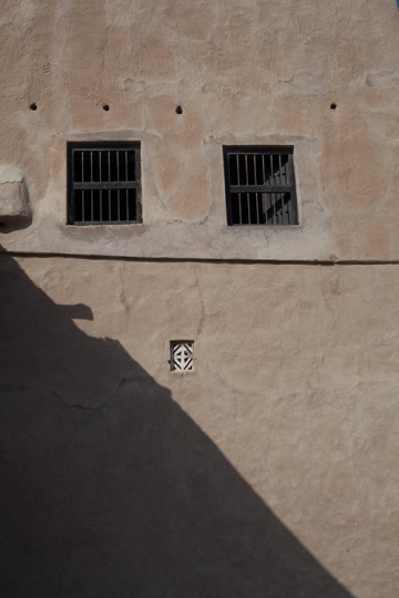 windows on a wall of an old building