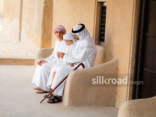 Family sitting outside|-