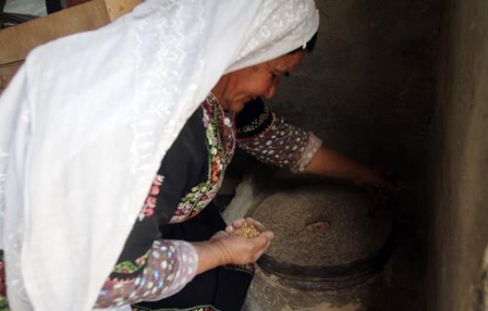 woman grinding seeds