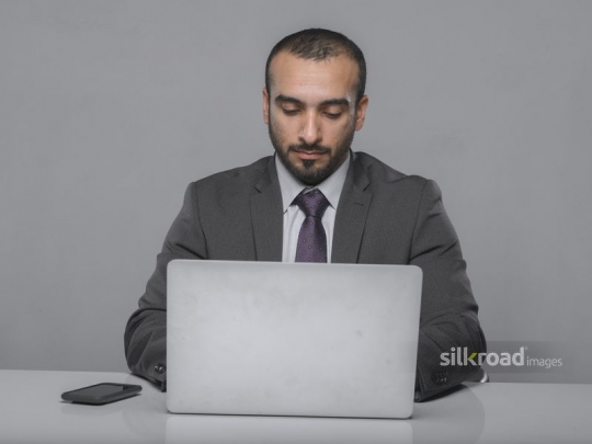 Arab Businessman working on the laptop