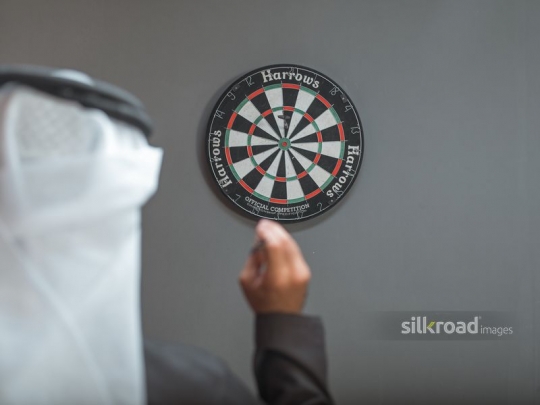 Arab man playing darts