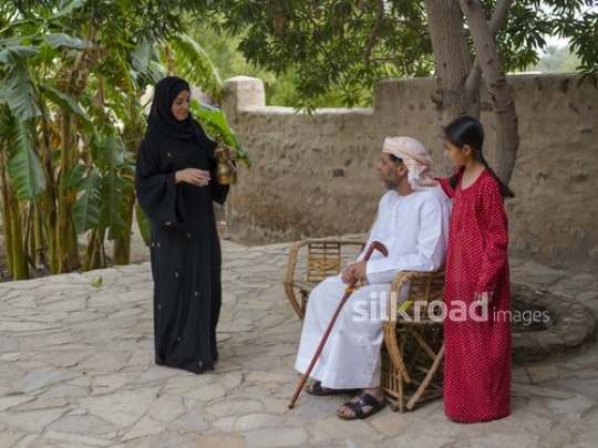 Mother serving arabic coffee|-