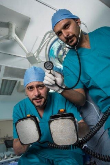 Surgeons Holding Electric Cardioversion and Surgical Tools