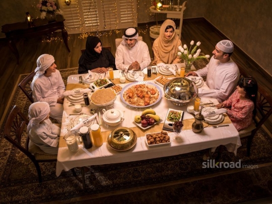 Family around iftar table|-