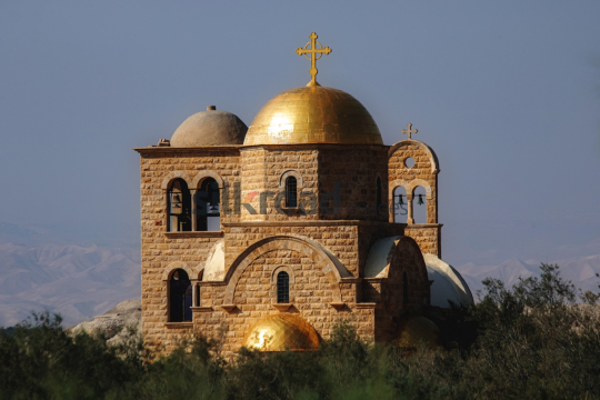 Golden Dome and Cross on Madaba Church with Stunning Mountain View