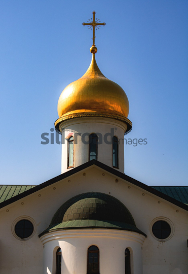 Golden Dome of Church in Madaba, Jordan with Clear Blue Sky