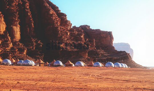 Luxury Desert Camp in Wadi Rum Jordan with Tented Lodges Against Majestic Rocky Mountains
