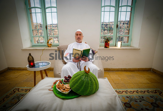 man-old-read-quran-ramadan-city-background-01