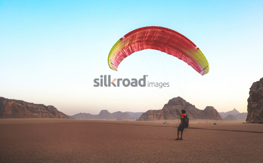 Paraglider in Wadi Rum Desert, Jordan at Sunrise