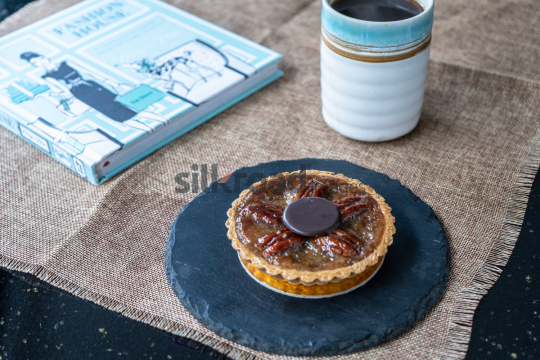 Pecan Tart with Coffee and Cookbook on Slate Plate