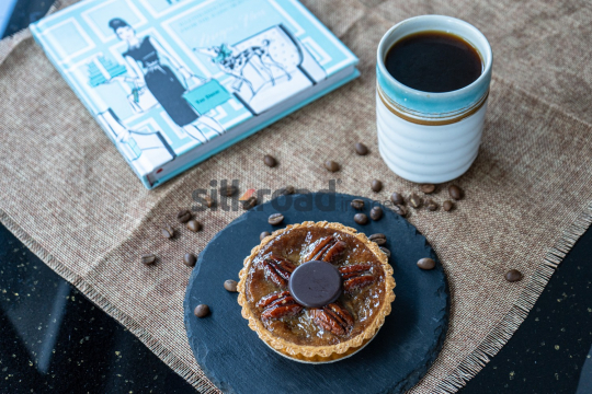 Pecan Tart with Coffee and Cookbook on Slate Plate