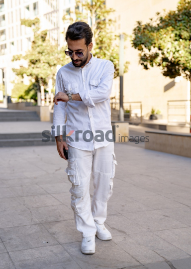Professional Man Checking Time in Al Abdali Boulevard, Amman