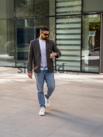 Professional Man Exiting Corporate Building