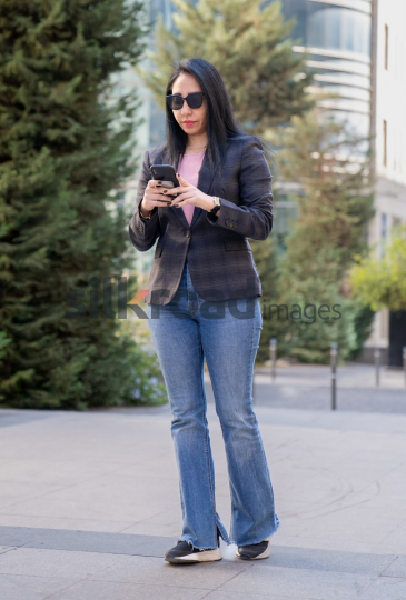 Professional Woman Walking in Al Abdali Boulevard with Green View