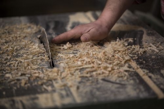 Woodworker cleaning the dust