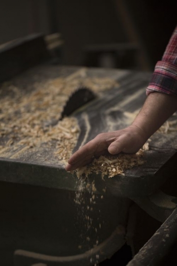 Cleaning the wood dust from the table
