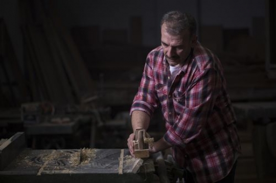 European worker cleaning the wood