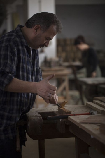 Worker cutting the wood