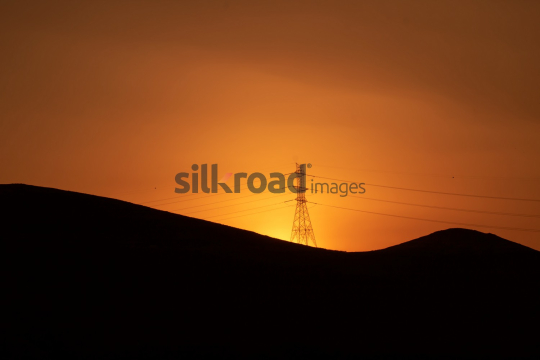 Silhouette of Electricity Tower Against Stunning Sunset