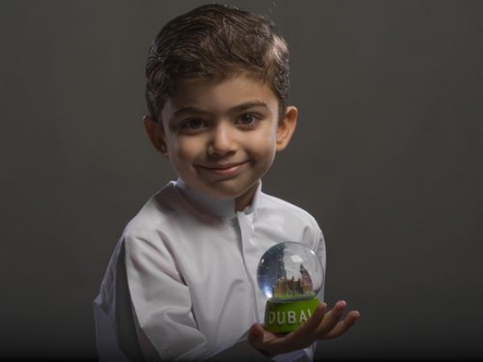 Arabian boy holding snowball
