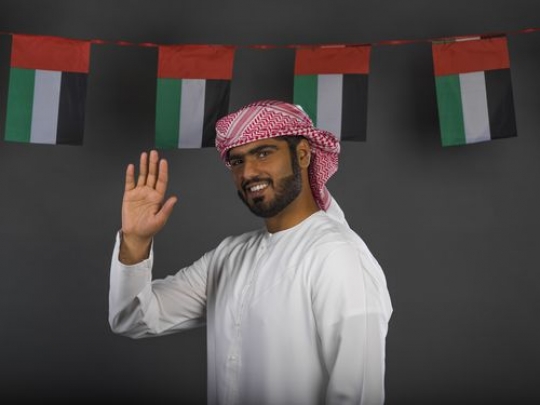 Middle Eastern man waving