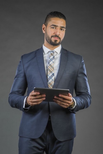 Businessman in a suit using device|-