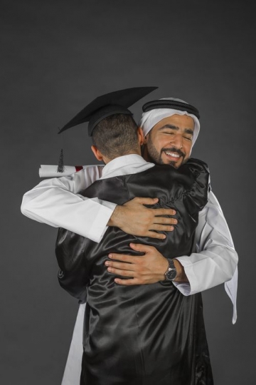 A Proud Middle Eastern father hugging his son