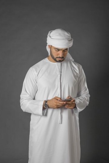 Middle Eastern man using his mobile|-