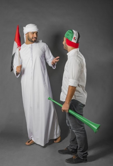 Middle Eastern men talking about National Day