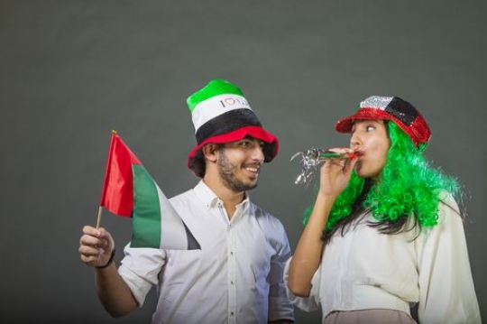 Arab woman and Arab man celebrating the UAE National Day together