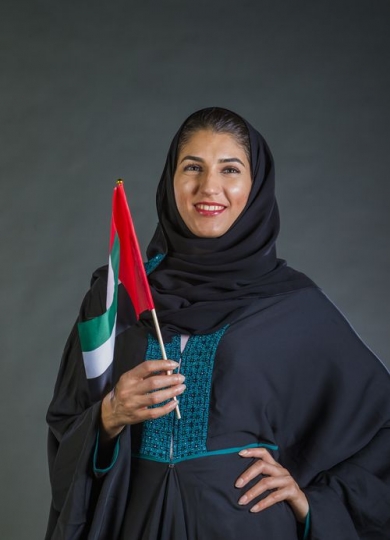 Middle Eastern woman smiling and representing her country