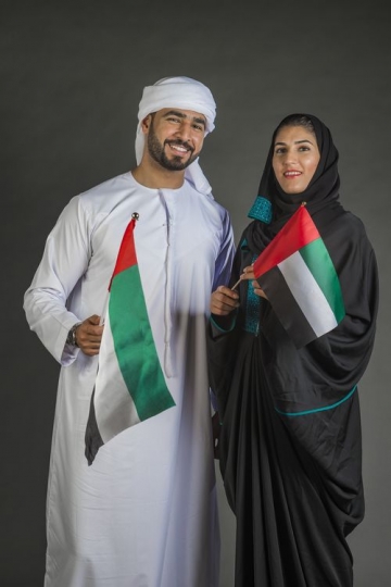 Arab Man and Woman carrying the UAE flag