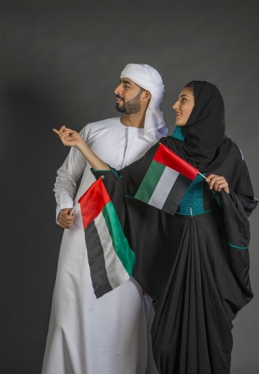 Man and Woman carrying the UAE flag