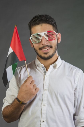 A Man carrying the UAE Flag
