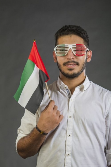 A Man carrying the UAE Flag