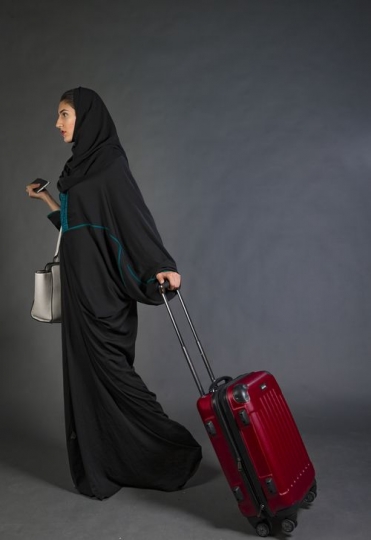 Businesswoman walking with her carry on|-