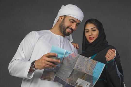 Arab man and woman looking at the map together|-