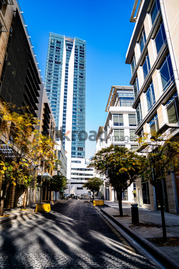 Tall Building in Al Abdali Boulevard with Autumn-Colored Trees Lining the Road
