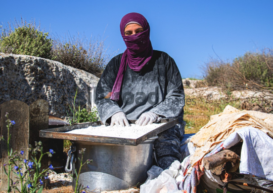 Woman Sifting Flour for Traditional Bread Making Outdoors