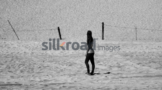 Woman Walking on Desert Sand in Black and White