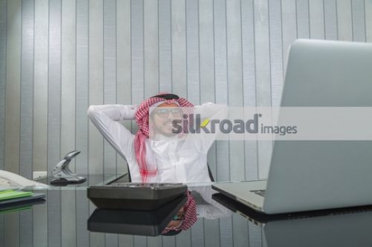 Man sitting at his desk smiling