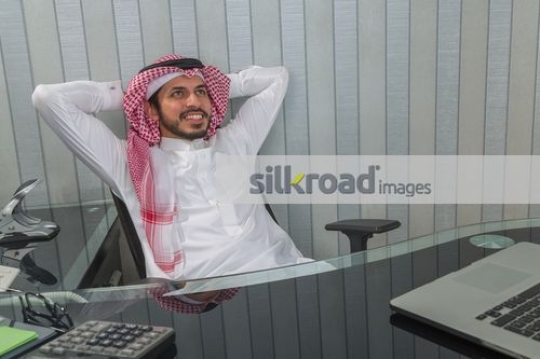 Businessman sitting at the chair excited