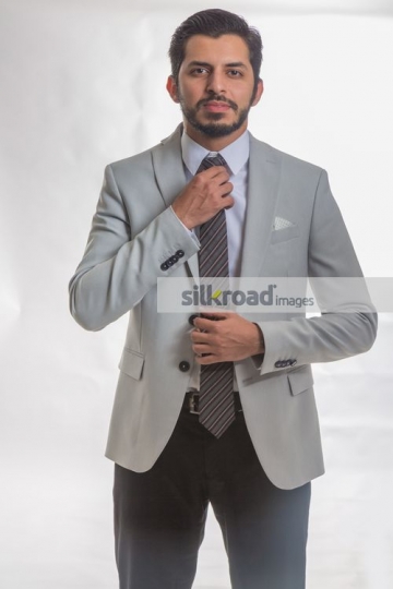Businessman fixing tie